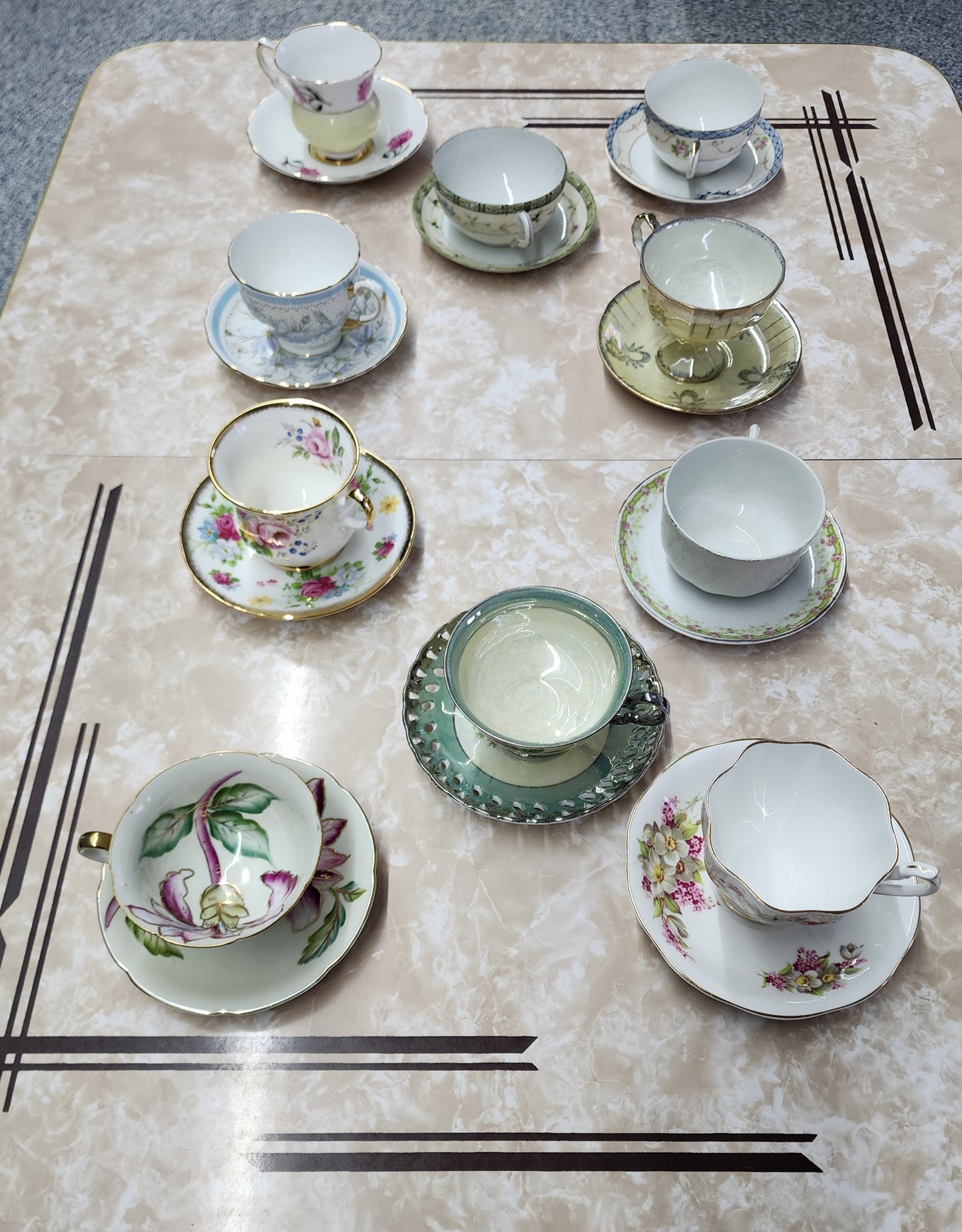Set of 10 teacups with saucers