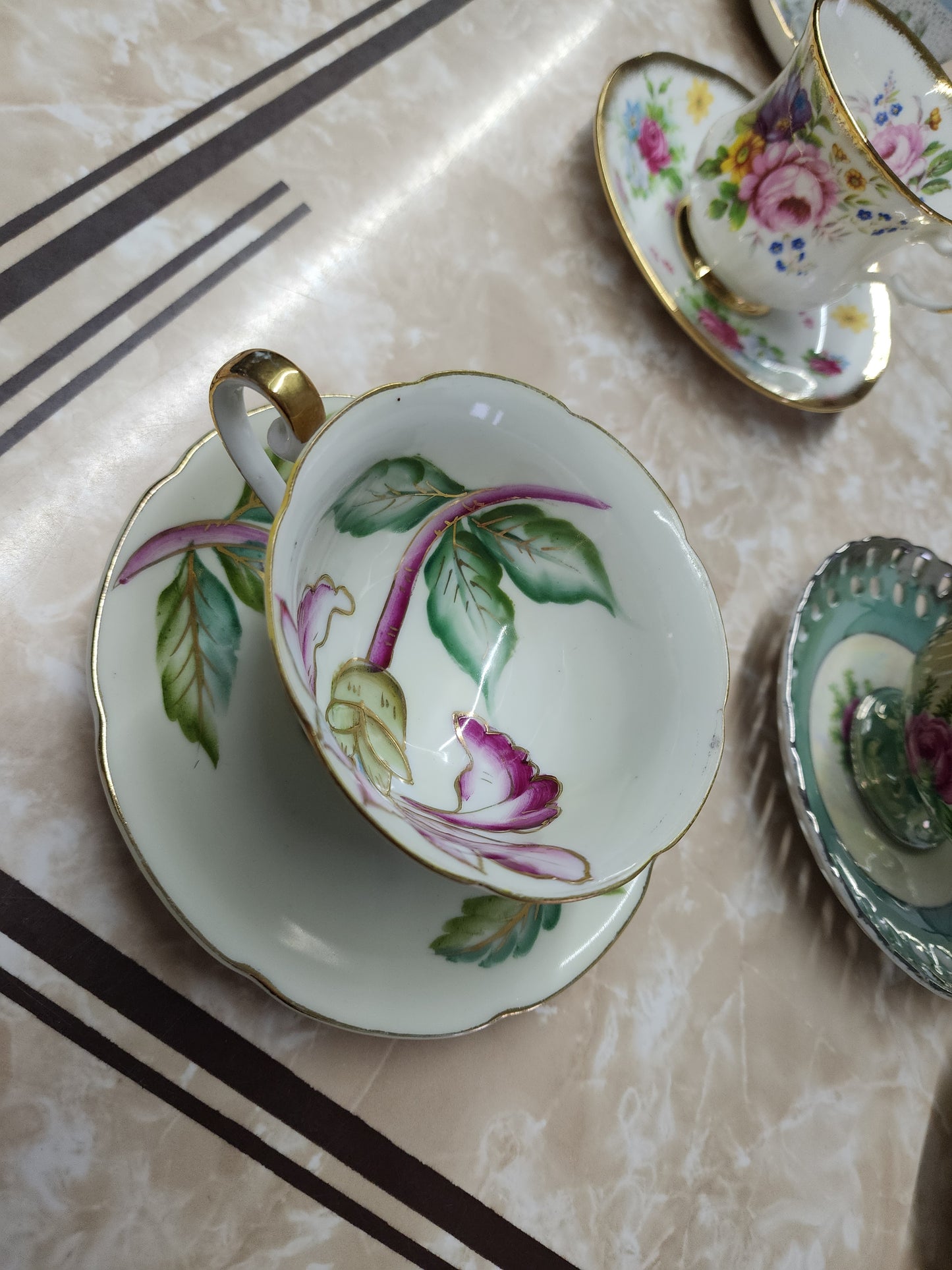 Set of 10 teacups with saucers