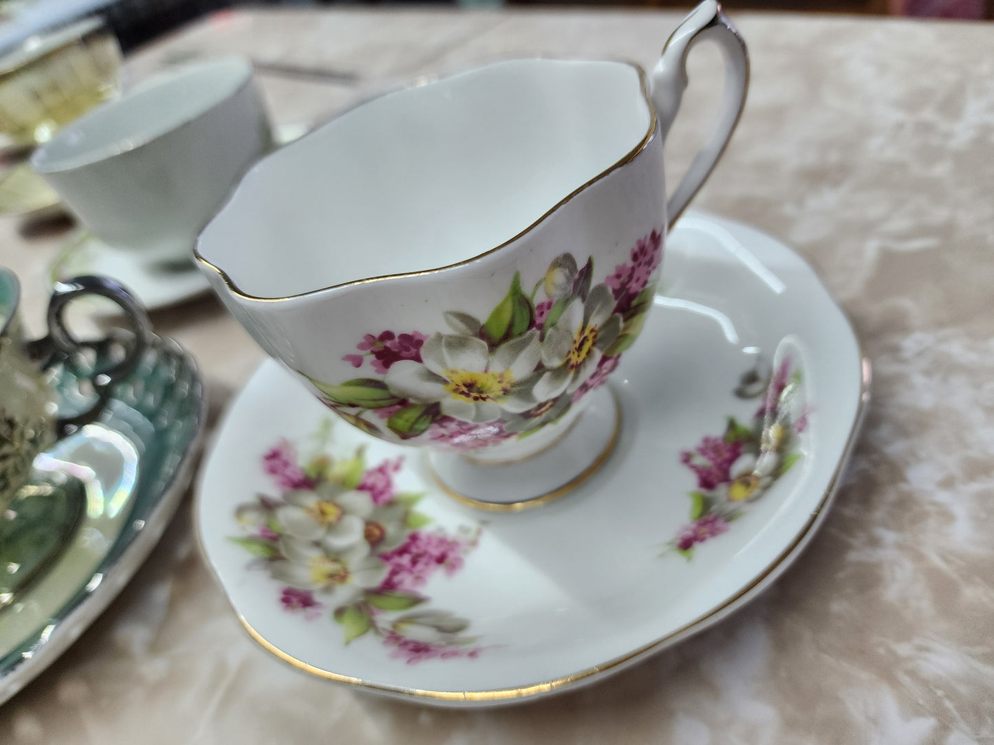 Set of 10 teacups with saucers