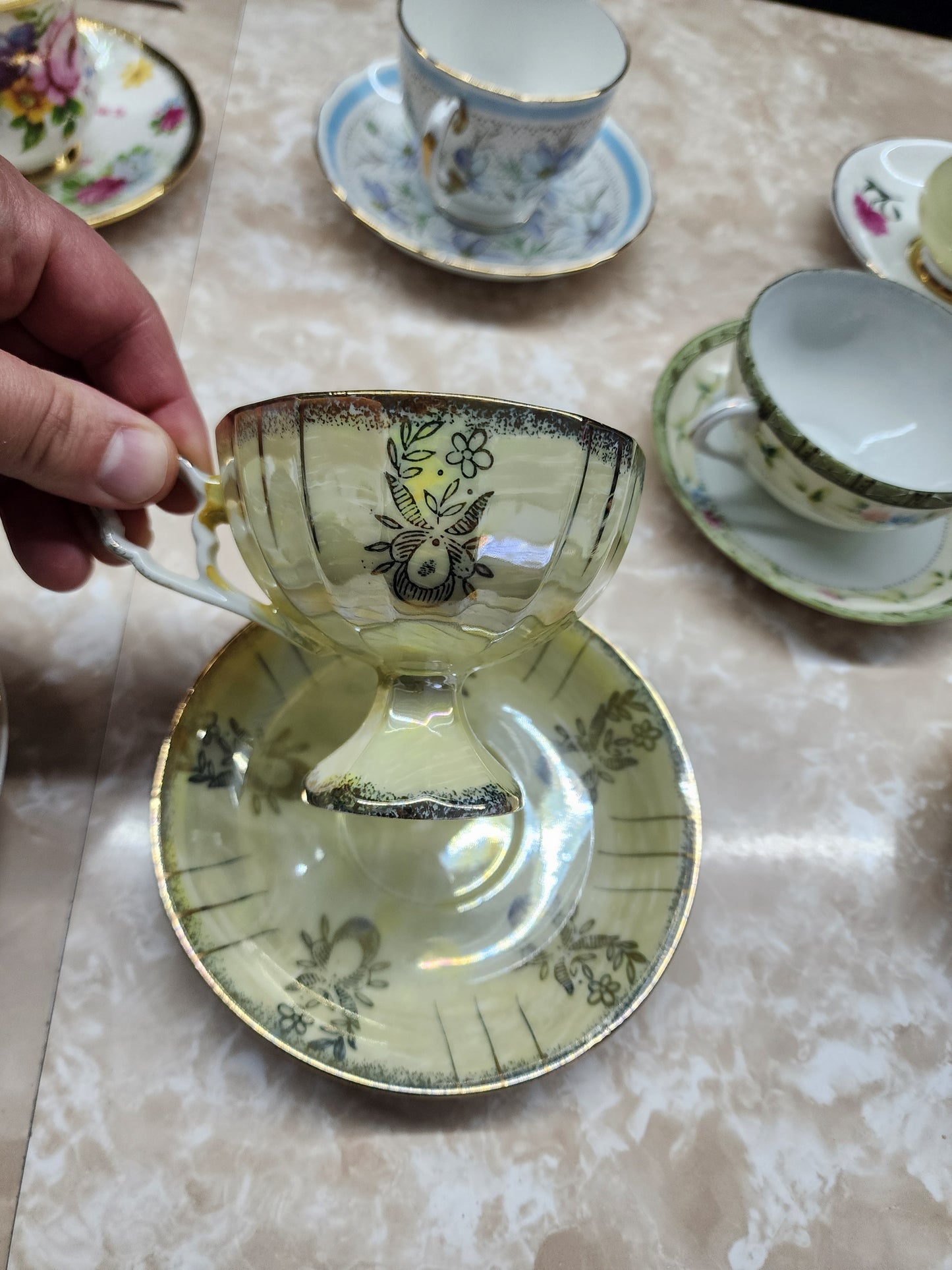 Set of 10 teacups with saucers