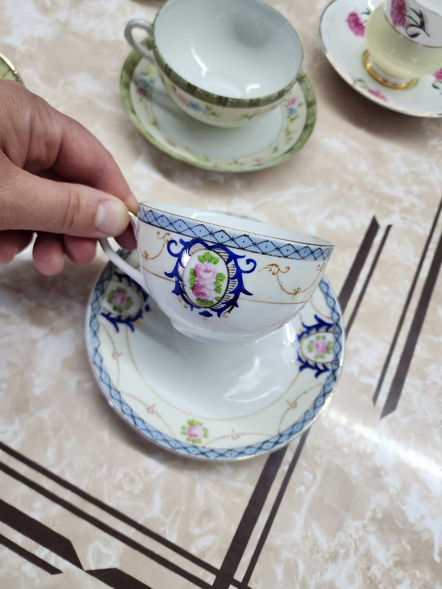 Set of 10 teacups with saucers