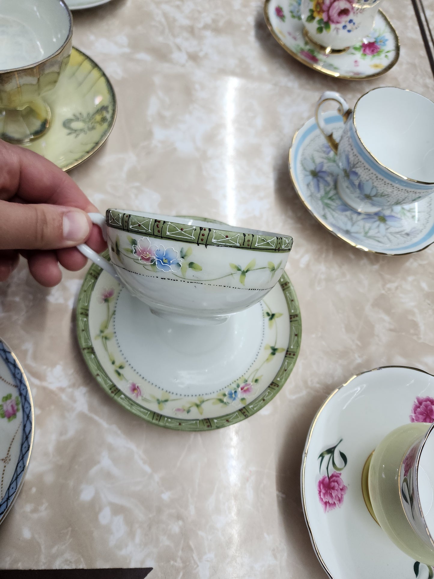 Set of 10 teacups with saucers